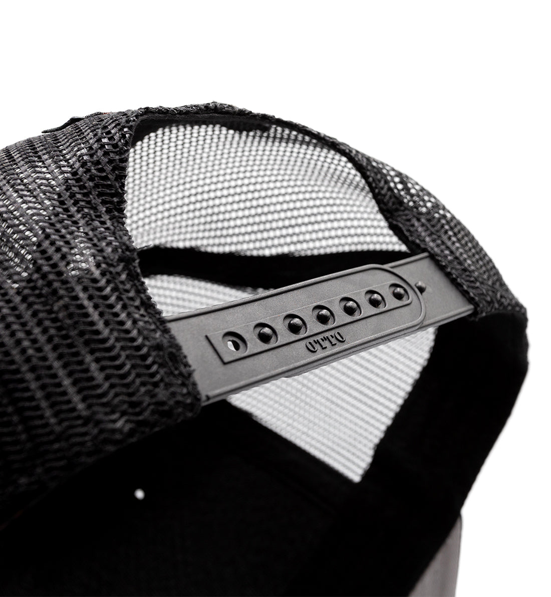 Black Fuel DEPARTURE Trucker Hat with a curved brim and white mesh back, featuring an embroidered logo on the front.