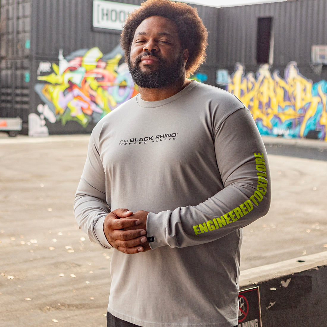 Black Rhino CORE Long Sleeve Tee in grey, featuring a round neckline and branded logo on the chest, displayed in a lifestyle setting.