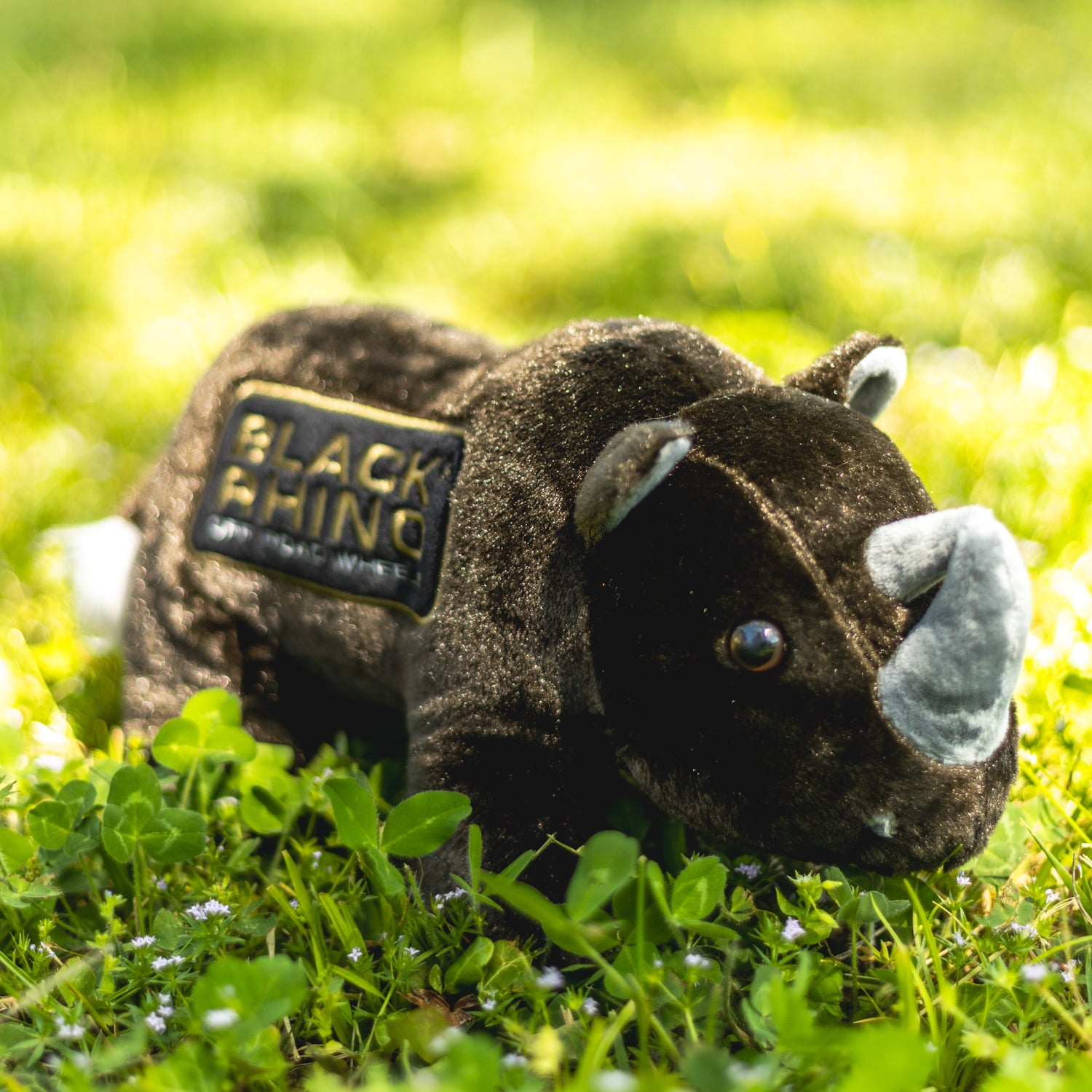 Black Rhino plush toy featuring a soft, grey body, large ears, and an adorable smiling face, perfect for cuddling.