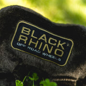 Black Rhino plush toy with soft fur, large ears, and a friendly expression, designed for children and collectors.