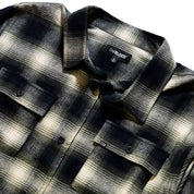Black Rhino flannel long sleeve shirt in a plaid pattern, featuring a classic button-up front and cuffed sleeves, displayed against a neutral background.