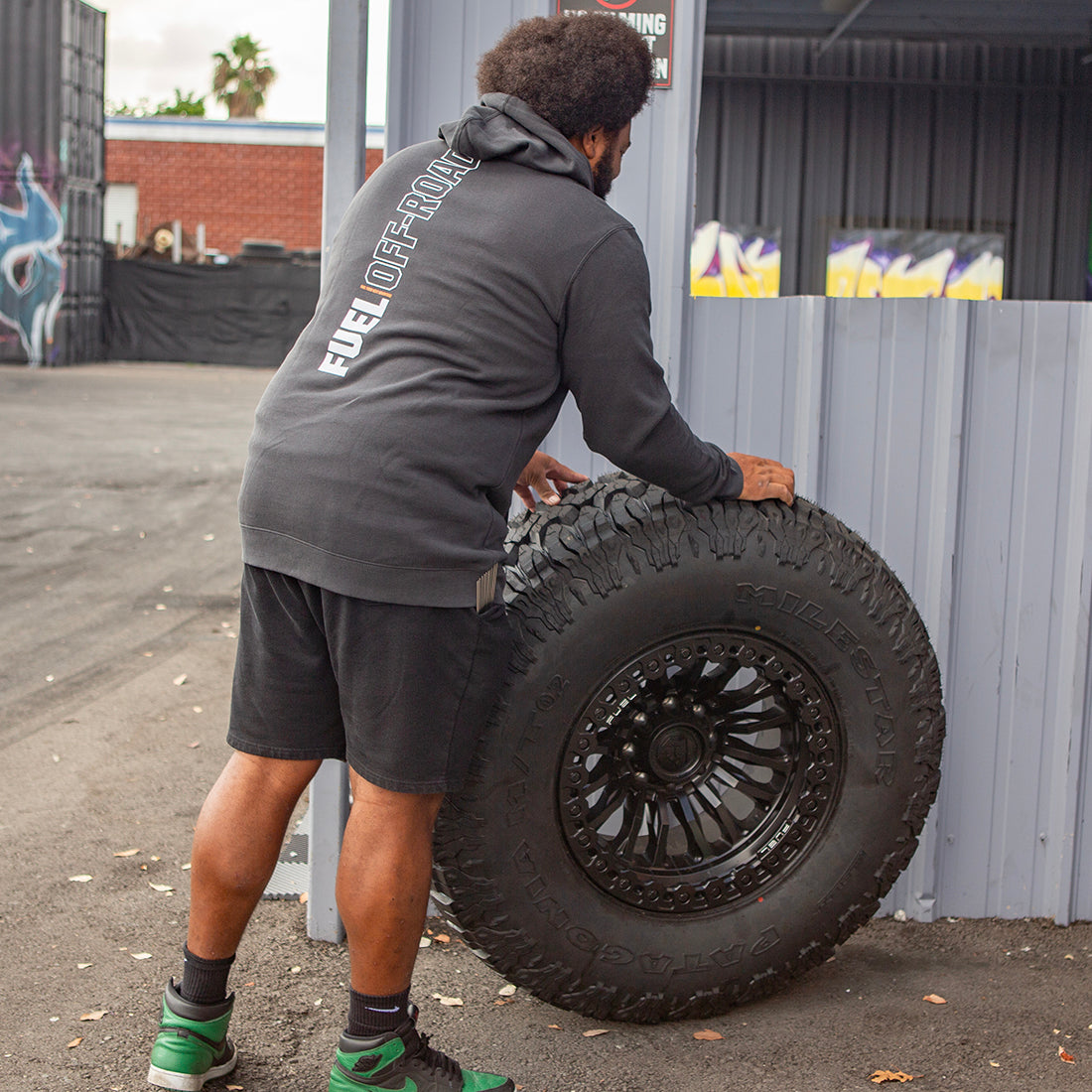Fuel CUT Pullover Hoodie in gray, showcasing a back view with a modern design and lifestyle setting.