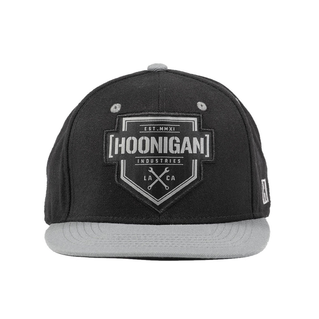 Hoonigan BRACKET X LOGO Snapback Hat in black and gray with a prominent logo on the front.