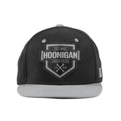 Hoonigan BRACKET X LOGO Snapback Hat in black and gray with a prominent logo on the front.