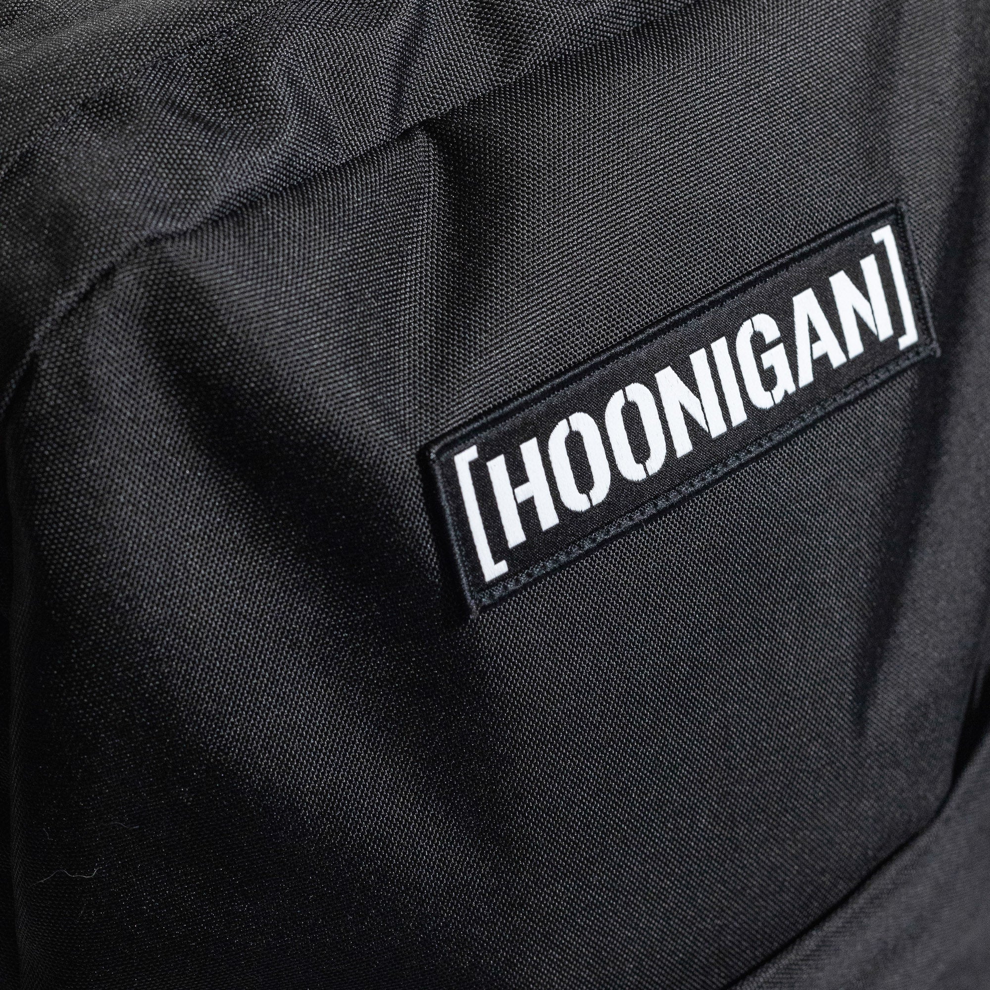 Hoonigan CENSOR BAR Light Backpack in black, featuring a graphic design and adjustable straps.