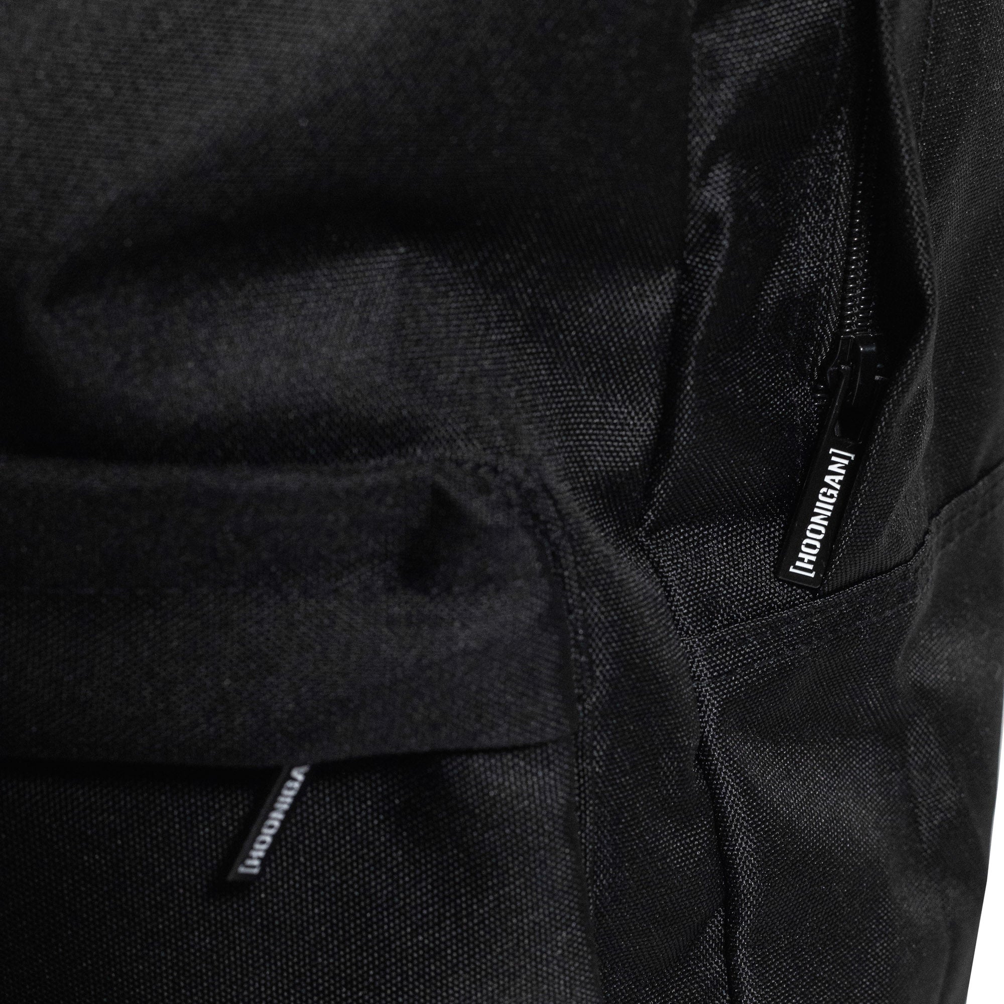 Hoonigan CENSOR BAR Light Backpack in black with a bold logo design and adjustable straps.