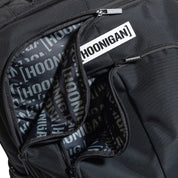 Hoonigan METAL BAR Backpack featuring a sleek black design with a prominent logo and multiple compartments.