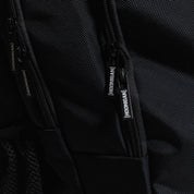 Hoonigan METAL BAR Backpack featuring a sleek black design with bold white logo and adjustable straps, perfect for casual outings and sports activities.