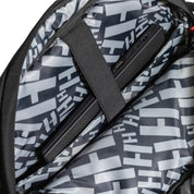 Hoonigan RATCHET STRAP Backpack with adjustable straps and logo detailing, featuring a sleek black design.