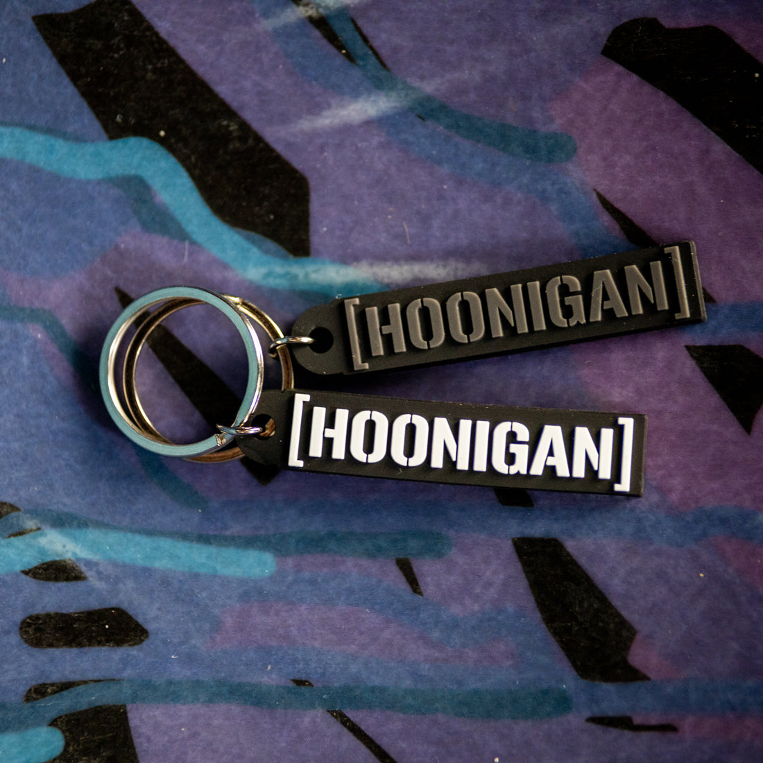 Hoonigan CENSOR BAR Rubber Keychain featuring a black and white design, with the Hoonigan logo and censor bar graphic.
