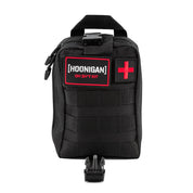 Black Hoonigan OH SH*T Safety Kit bag with red and white logo patch, red cross patch, and multiple compartments for safety gear.