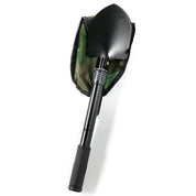 Black shovel with a textured grip handle, attached to a green and black safety kit bag, designed for emergency use.
