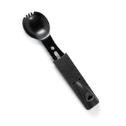Black plastic spoon with a textured handle and a slotted, rounded scoop, part of the Hoonigan OH SH*T Safety Kit.