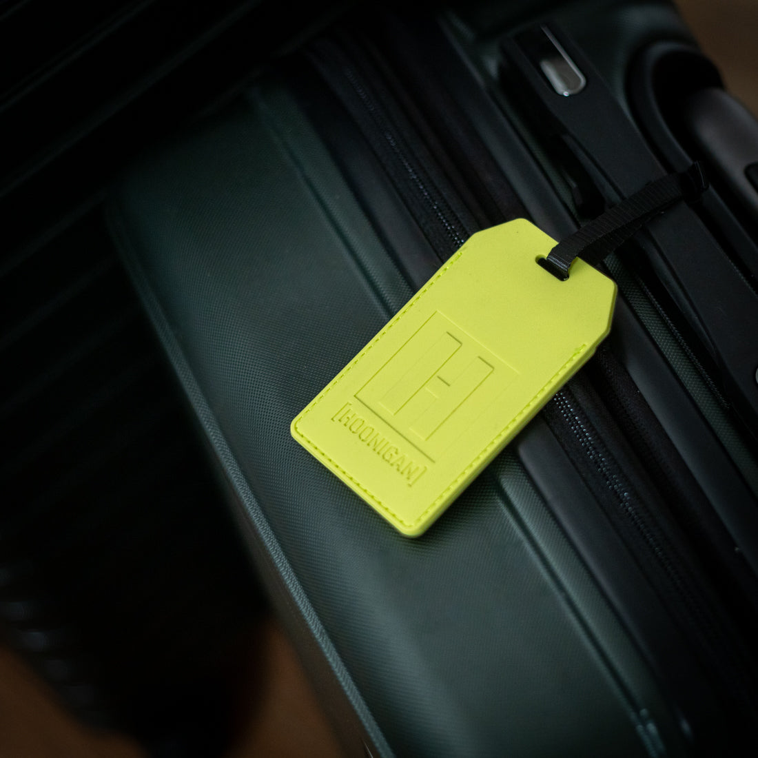 Hoonigan HI VIZ Luggage Tag in bright yellow with black text and logo design.