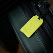 Hoonigan HI VIZ Luggage Tag in bright yellow with black text and logo design.