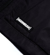 Hoonigan Standard Issue Windbreaker Jacket in black and white, featuring a front pocket and logo detail.