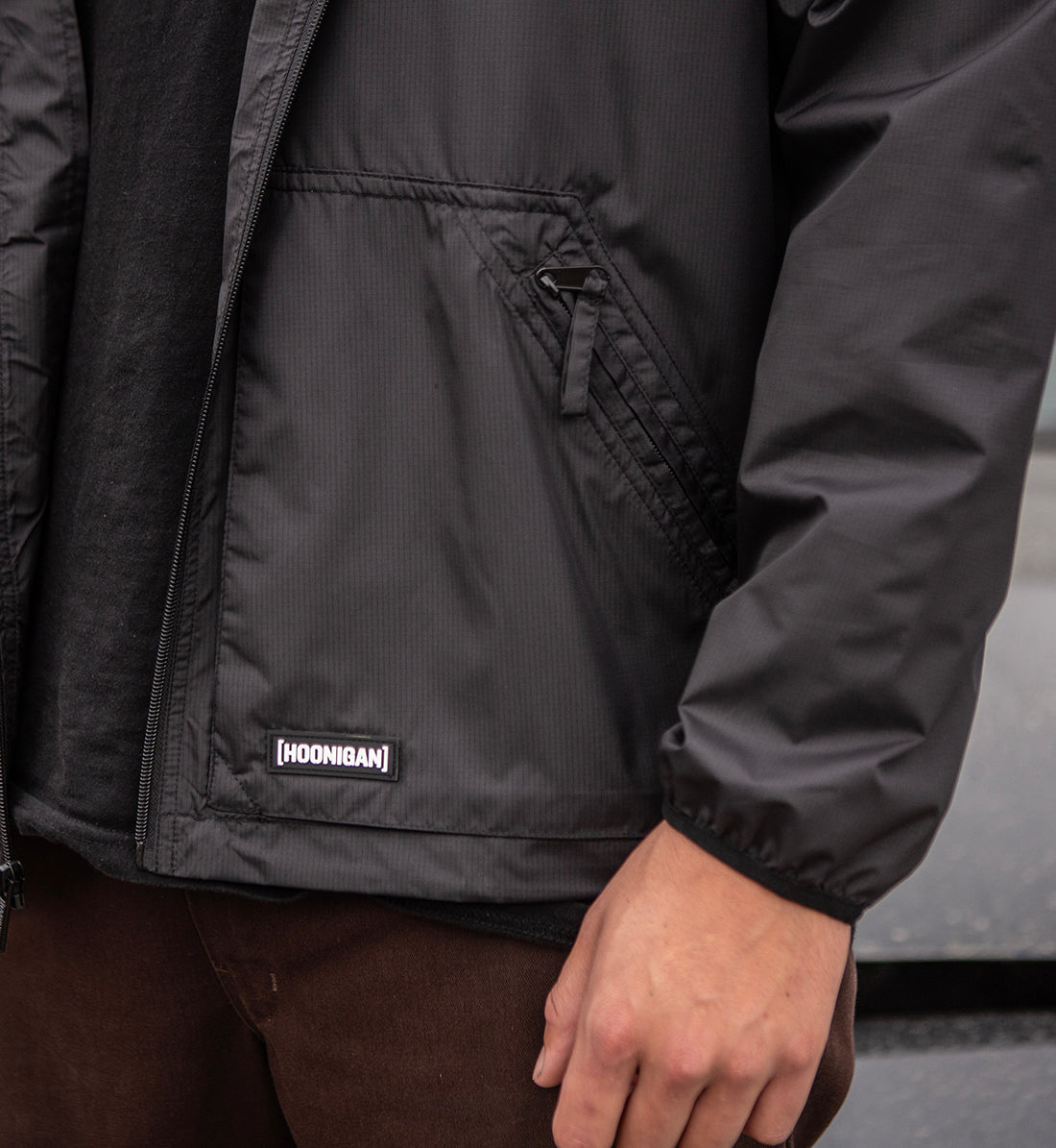 Hoonigan STANDARD ISSUE windbreaker jacket featuring a black and white design, front detail view.