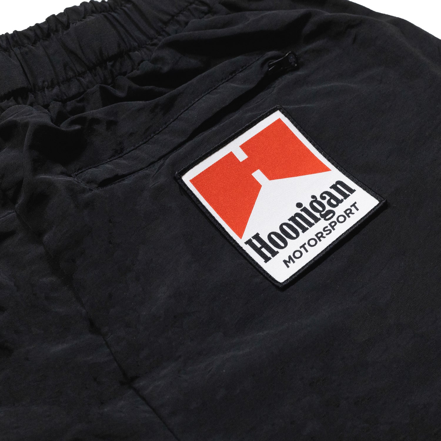 Hoonigan SURGEON GENERAL nylon shorts in black, featuring a white logo and design elements on the sides.