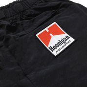 Hoonigan SURGEON GENERAL nylon shorts in black, featuring a white logo and design elements on the sides.