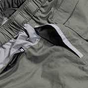 Close-up of Hoonigan H.A.V.O.C. rain-activated cargo shorts showing water-resistant fabric, zippered pocket, and elastic waistband.