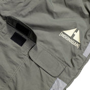 Close-up of gray Hoonigan H.A.V.O.C. rain-activated cargo shorts featuring a logo patch, Velcro pocket, and durable fabric.