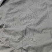 Close-up of Hoonigan H.A.V.O.C. rain-activated cargo shorts fabric with topographic line pattern and water-repellent texture.