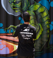 Hoonigan CHEATER SLICKS Short Sleeve Tee, black, featuring a logo graphic on the back, styled in a lifestyle setting.