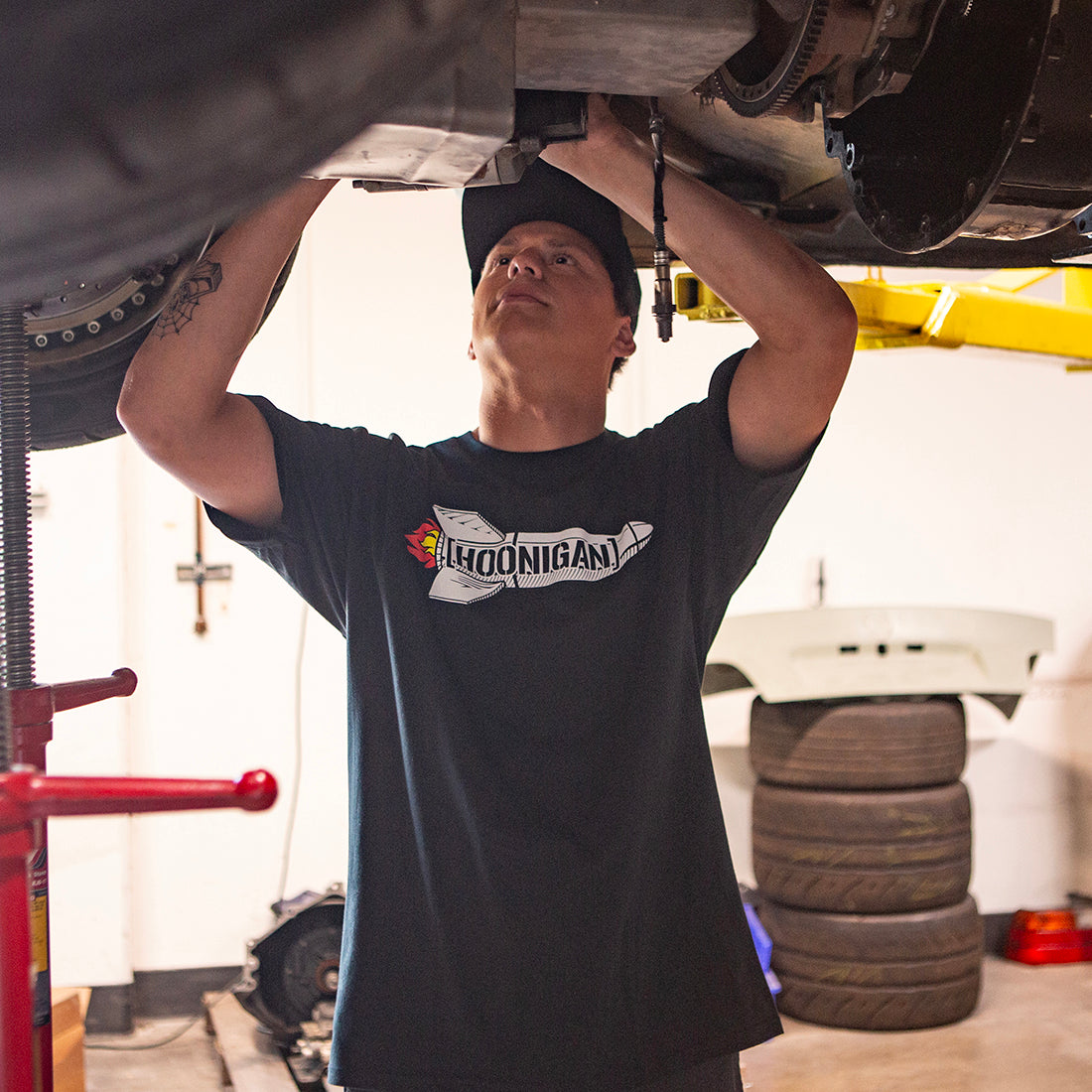 Hoonigan ROCKET Short Sleeve Tee in a lifestyle setting, featuring bold graphics and a relaxed fit on a model outdoors.