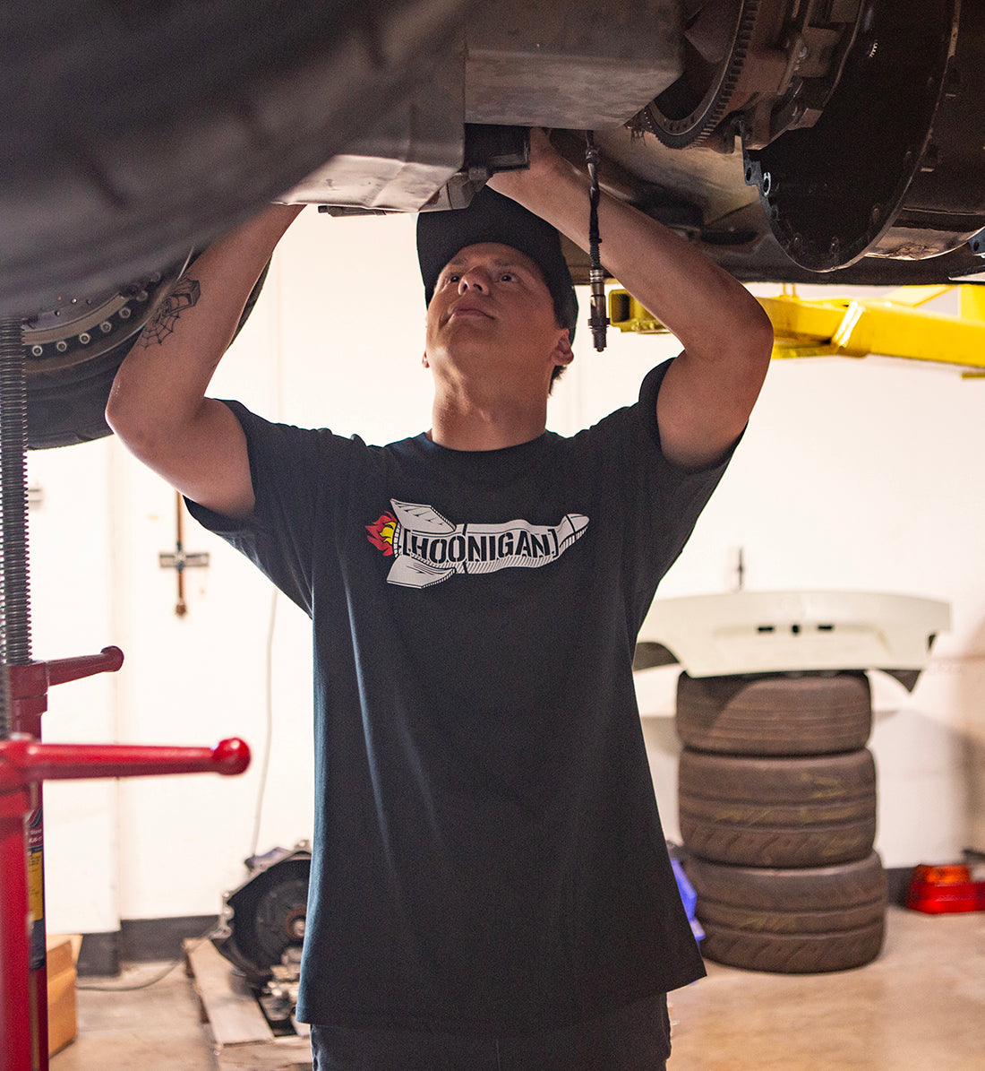 Hoonigan ROCKET Short Sleeve Tee in a lifestyle setting, featuring bold graphics and a relaxed fit on a model outdoors.