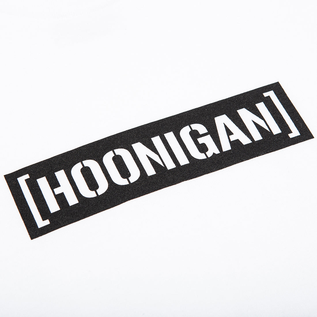 Hoonigan New Standard Bar Short Sleeve Tee in black with bold white logo print, displayed on a flat surface.