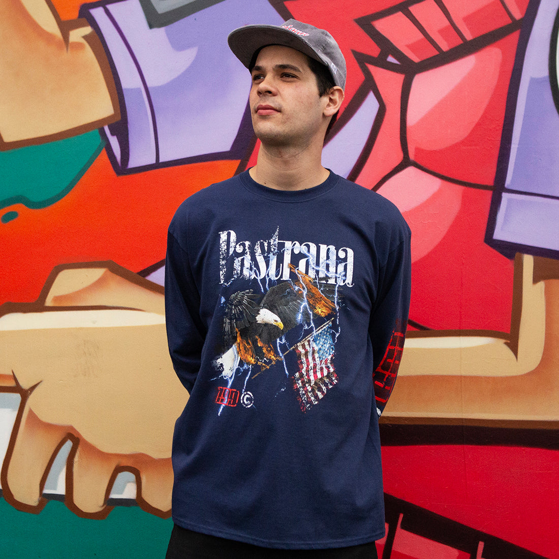 Travis Pastrana FLY HIGH Long Sleeve Tee in navy blue, featuring a bold graphic design, worn casually outdoors.