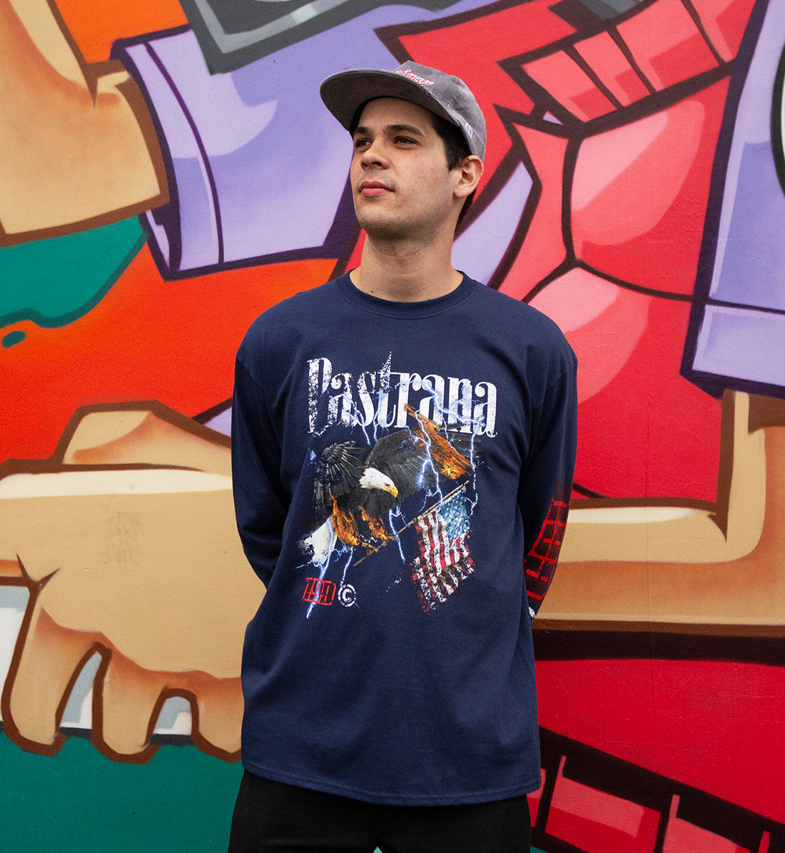 Travis Pastrana FLY HIGH Long Sleeve Tee in navy blue, featuring a bold graphic design, worn casually outdoors.