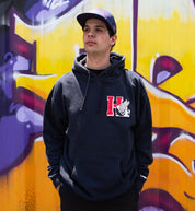 Hoonigan DROP OUT Pullover Hoodie in navy, featuring a front graphic design, relaxed fit, and drawstring hood, modeled in a lifestyle setting.