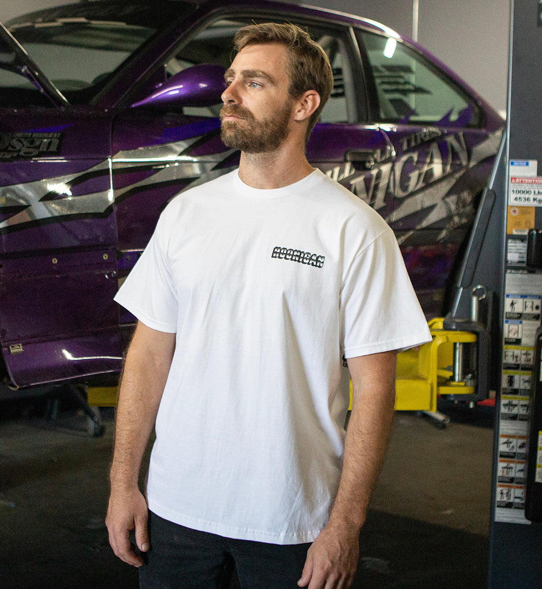 Hoonigan USED CARS Short Sleeve Tee in white, featuring a front graphic design of vintage cars.