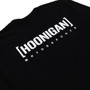 Hoonigan Motorsports Long Sleeve Tee featuring a bold graphic design on the back, black fabric with white detailing.