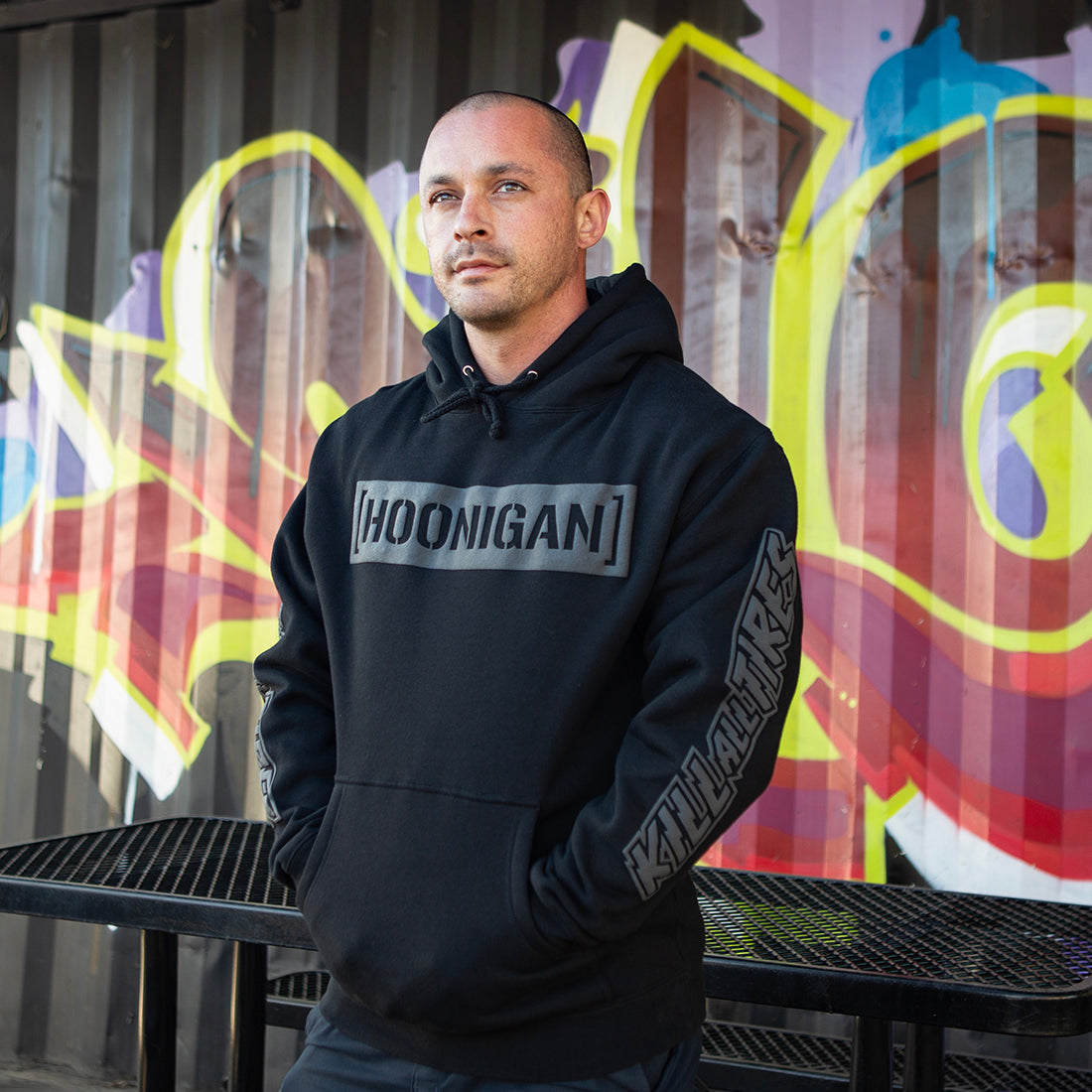 Black Hoonigan AIRBAGS CENSOR BAR Pullover Hoodie displayed in a lifestyle setting, featuring bold graphics on the front.