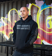 Black Hoonigan AIRBAGS CENSOR BAR Pullover Hoodie displayed in a lifestyle setting, featuring bold graphics on the front.