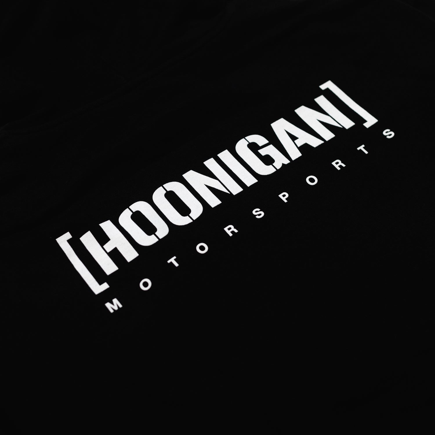 Black Hoonigan Motorsports pullover hoodie featuring a large logo graphic on the back and a front kangaroo pocket.