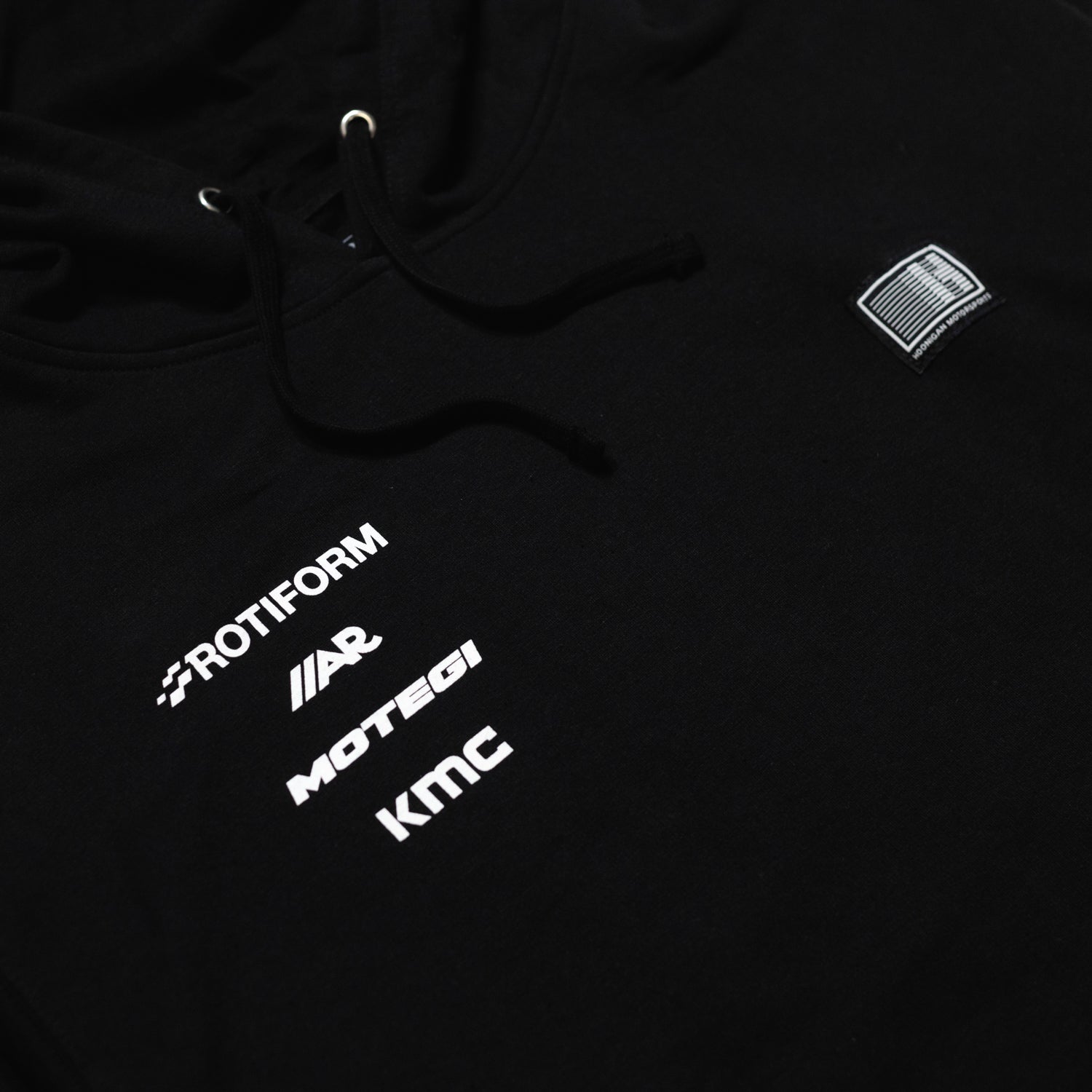 Hoonigan Motorsports black pullover hoodie featuring a front logo graphic, adjustable drawstring hood, and a front kangaroo pocket.