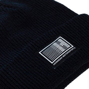 Black Hoonigan Motorsports beanie featuring a white logo on the front, ideal for motorsport enthusiasts.