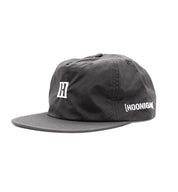 Hoonigan TIRE SLAYER unstructured snapback cap featuring a black and white design with a prominent logo on the front.