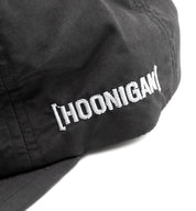 Hoonigan TIRE SLAYER unstructured snapback cap with black front and red embroidered logo, featuring a curved brim and adjustable strap.