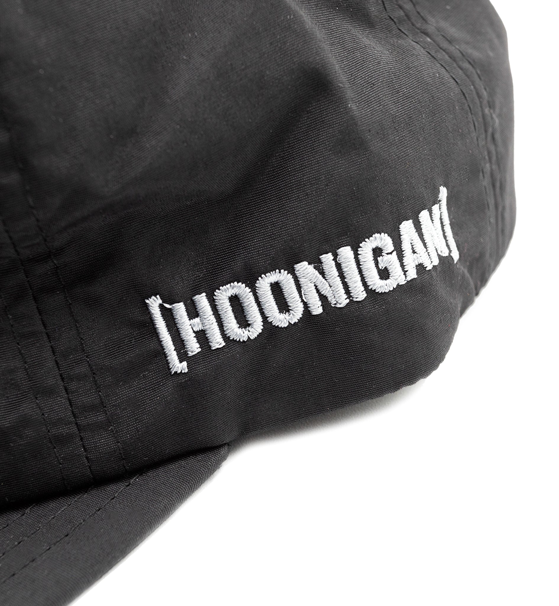 Hoonigan TIRE SLAYER unstructured snapback cap with black front and red embroidered logo, featuring a curved brim and adjustable strap.
