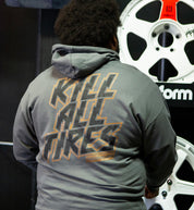 Hoonigan GYMKHANA7 KILL ALL TIRES pullover hoodie in black, featuring a graphic print on the back, being worn outdoors.