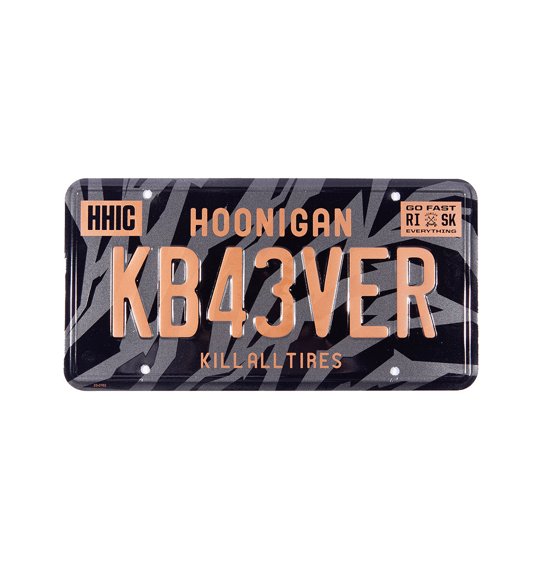 Hoonigan GYMKHANA7 metal license plate featuring a bold graphic design, mainly in black and white, with "GYMKHANA7" text prominently displayed.