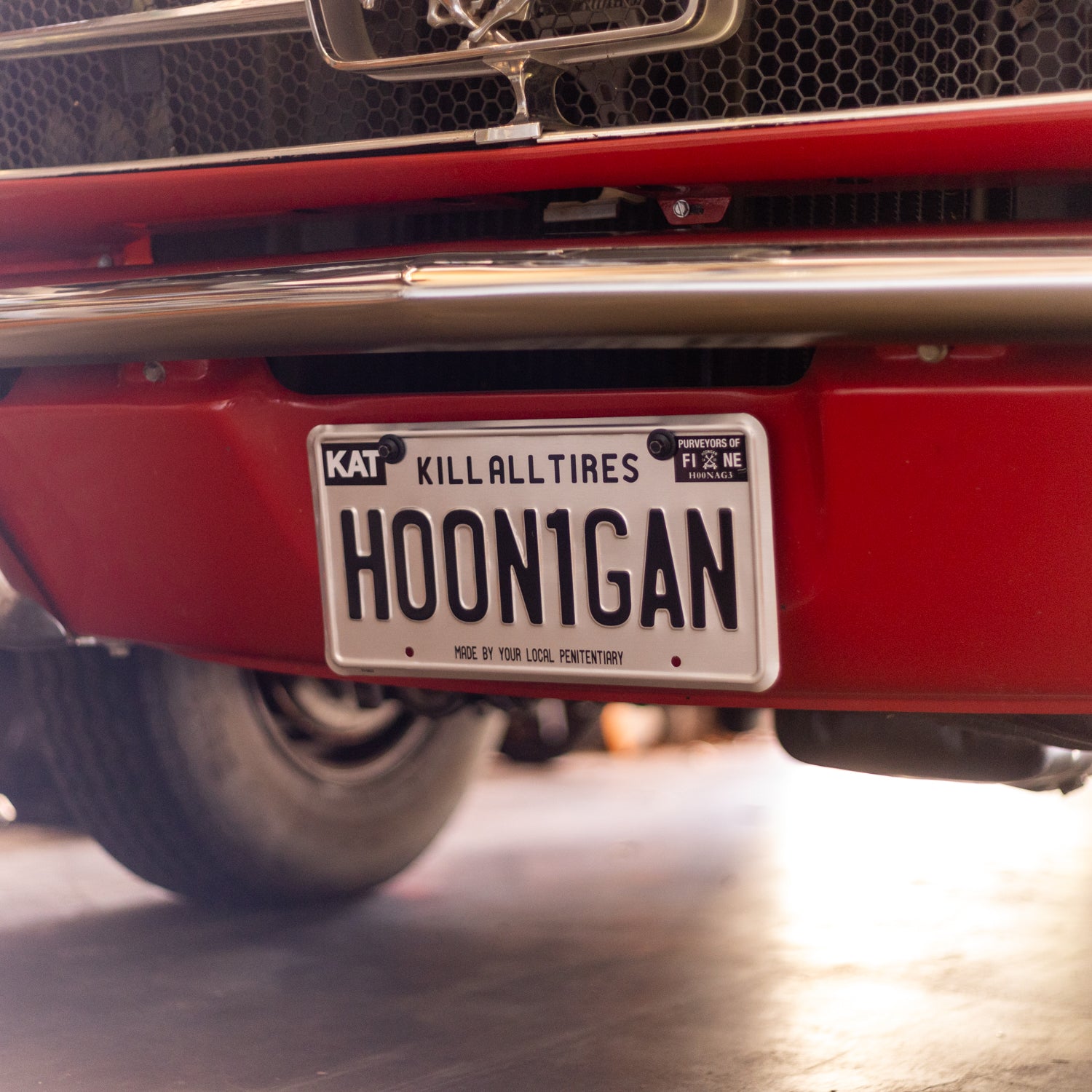 Hoonigan METAL License Plate featuring a bold design with the Hoonigan logo on a textured background.