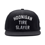 Hoonigan TIRE SLAYER Snapback Hat featuring a black base with bold white graphics and a flat brim.