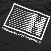 Hoonigan Motorsports Windbreaker Jacket featuring a bold back design with logos and graphics in a stylish black and red color scheme.