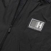 Hoonigan Motorsports windbreaker jacket featuring a bold front design in black and white.