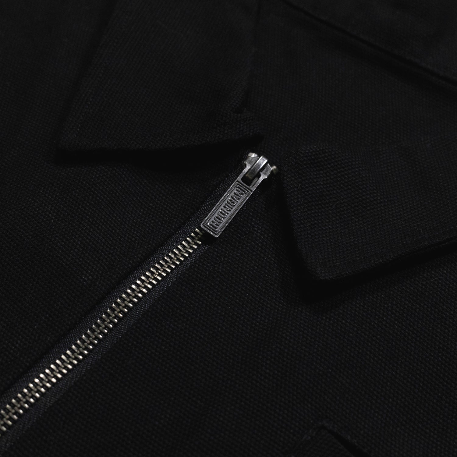 Hoonigan x Mooneyes MOON MOTEL black jacket featuring a retro motel logo on the back and a zip-up front design.